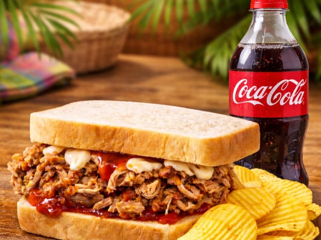 Tropical Paradise Pork Sandwich Combo with Chips and 20 oz. Soda Bottle.